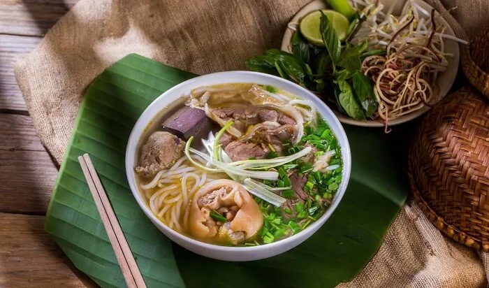 Bún Bò Huế, a spicy beef noodle soup from Hue, with lemongrass and herbs