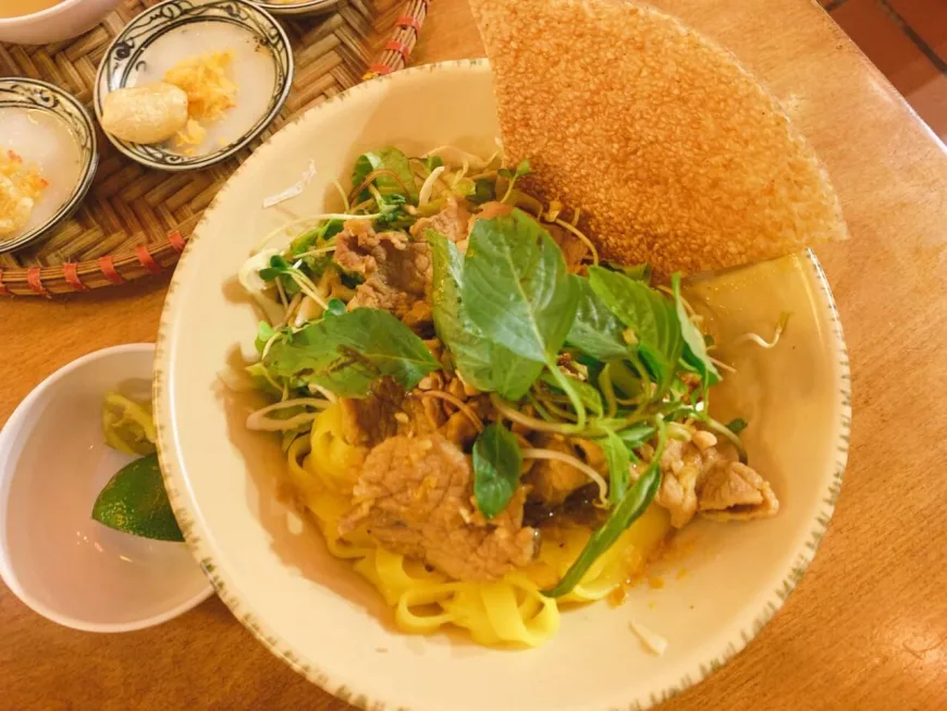 Mì Quảng with turmeric-infused rice noodles, shrimp, and fresh herbs